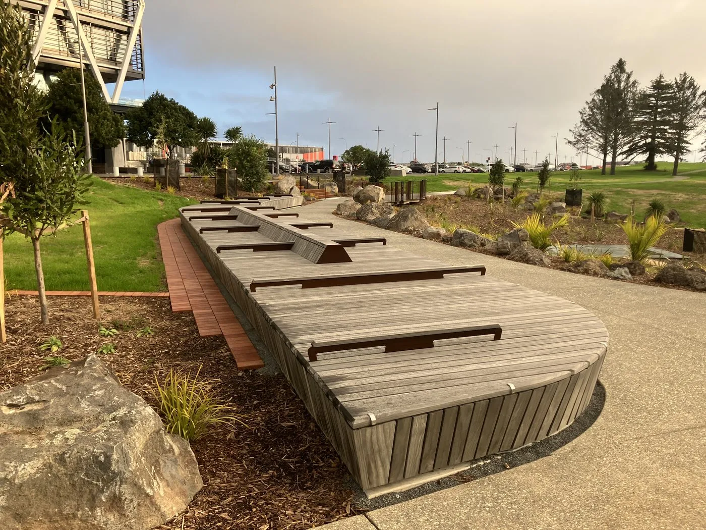 Timber seating beside new planting and the shared path at Hayman Park