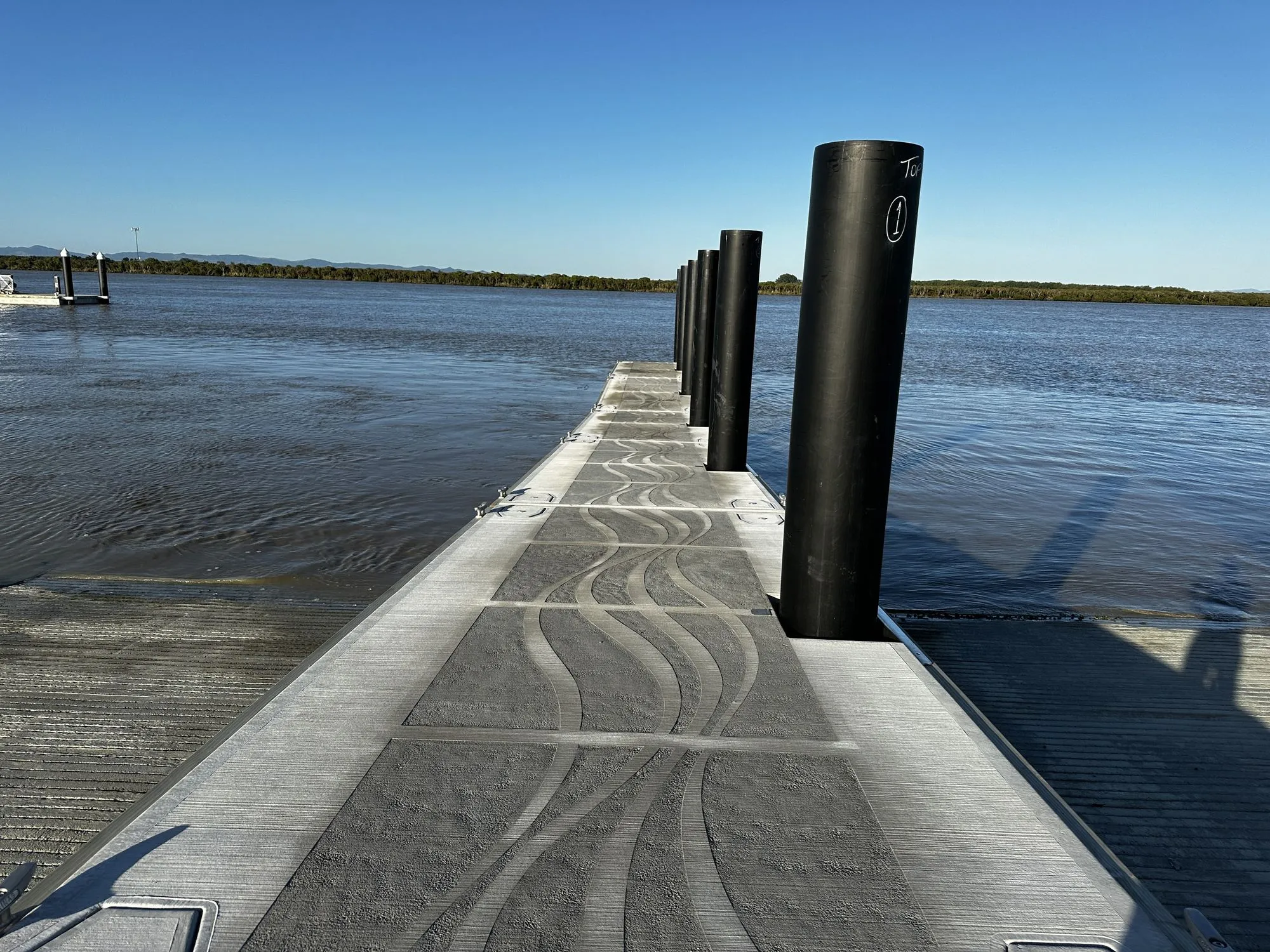 The finished Kōpū pontoon with koru-patterned deck on the Waihou River