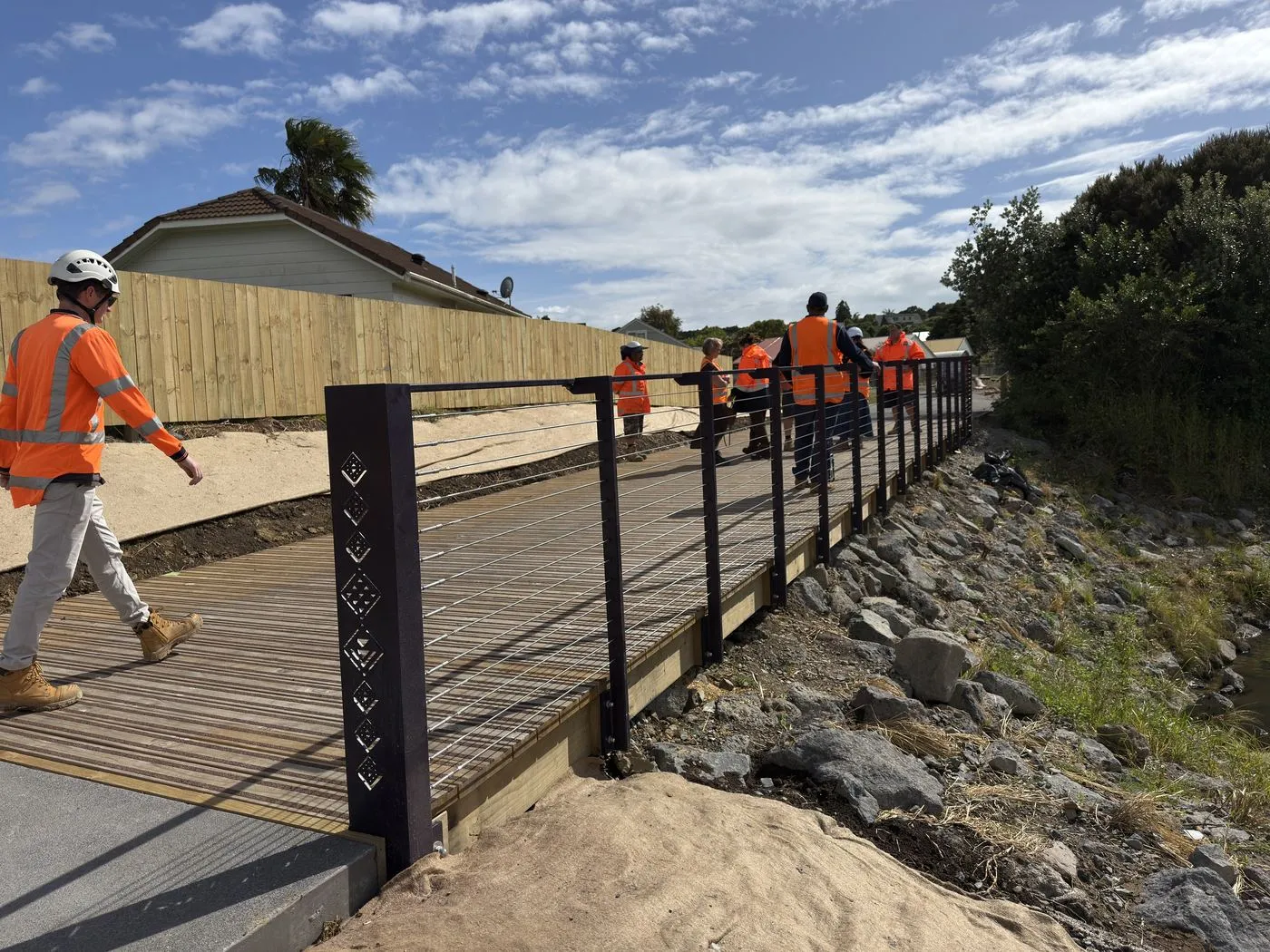 Engineers walking the new boardwalk above the stream at Te Aka Raataa